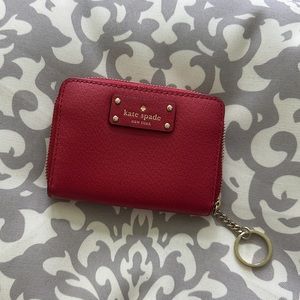 Kate Spade zip wallet with keychain. Red pebble leather. Elegant and practical.